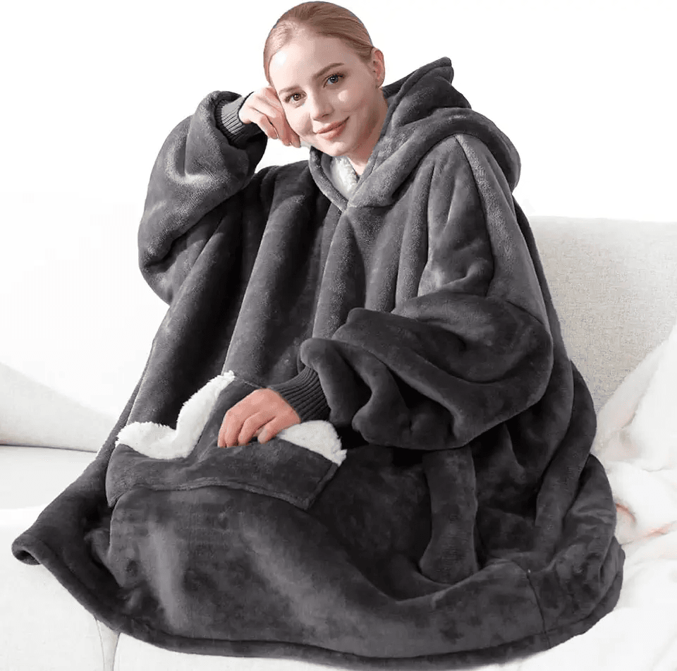 Showcases the comfort and warmth of the oversized wearable blanket Demonstrates the product's use in a comfortable, casual environment