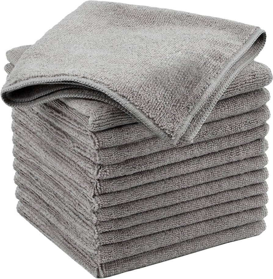 Showcases a stack of gray microfiber towels to highlight the product's quantity and texture.