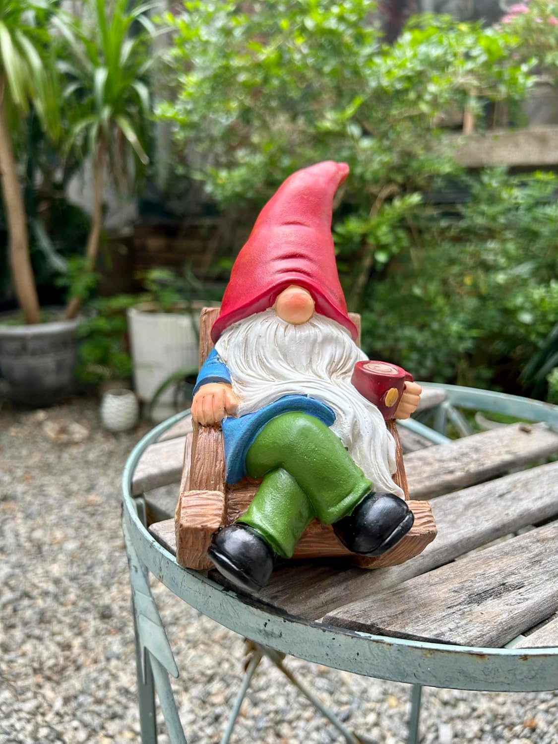 Shows the product in a realistic outdoor setting to demonstrate its use as a decorative garden ornament.