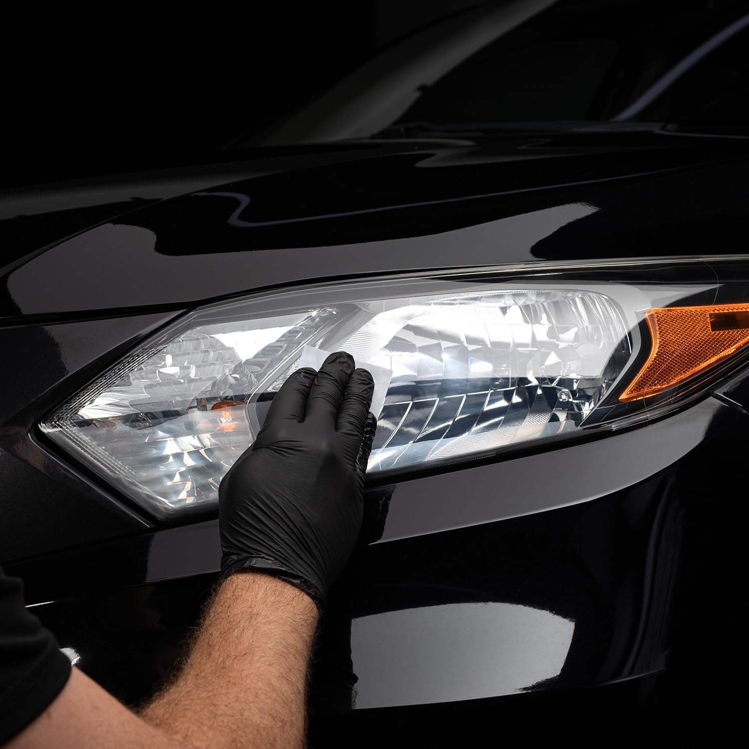 Demonstrates how to properly clean or maintain a vehicle's headlight, emphasizing the importance of regular care for optimal performance.