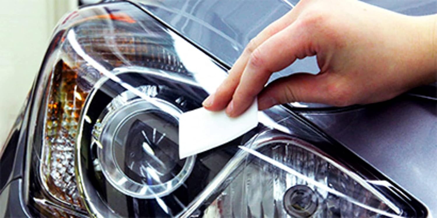 Demonstrates how to clean or polish a car headlight, showing the ease of use and potential for improving vehicle appearance.