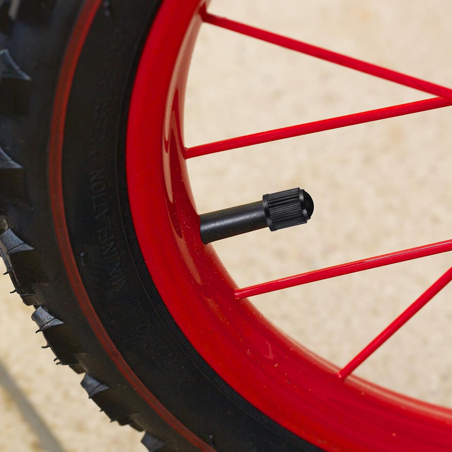 Highlights the presence of an air valve on the wheel, allowing for easy tire inflation and maintenance.