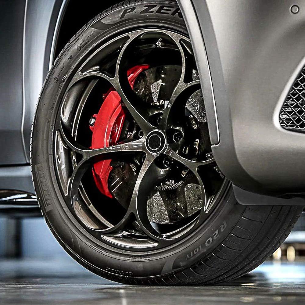 Highlights the vehicle's advanced braking system with large, red brake calipers visible through the wheel design, emphasizing performance and safety.