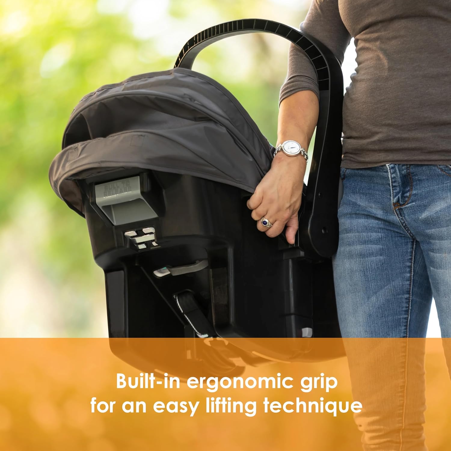 Highlights the built-in ergonomic grip feature of the stroller or car seat, emphasizing ease of use and comfort for parents.