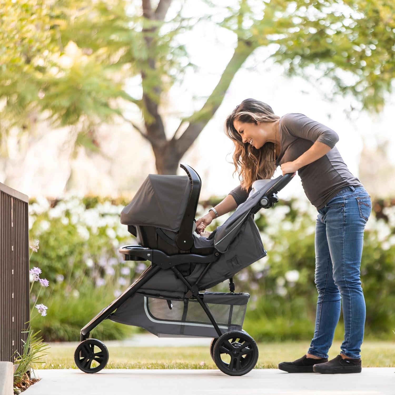 Shows the stroller being used in a natural outdoor setting, demonstrating its suitability for walks and outdoor activities.