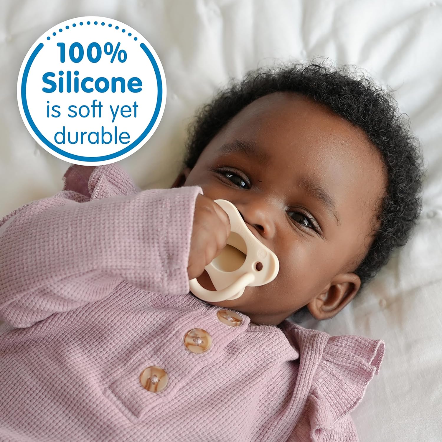 Highlights that the product (likely a pacifier) is made of 100% silicone, emphasizing its softness and durability for baby use.