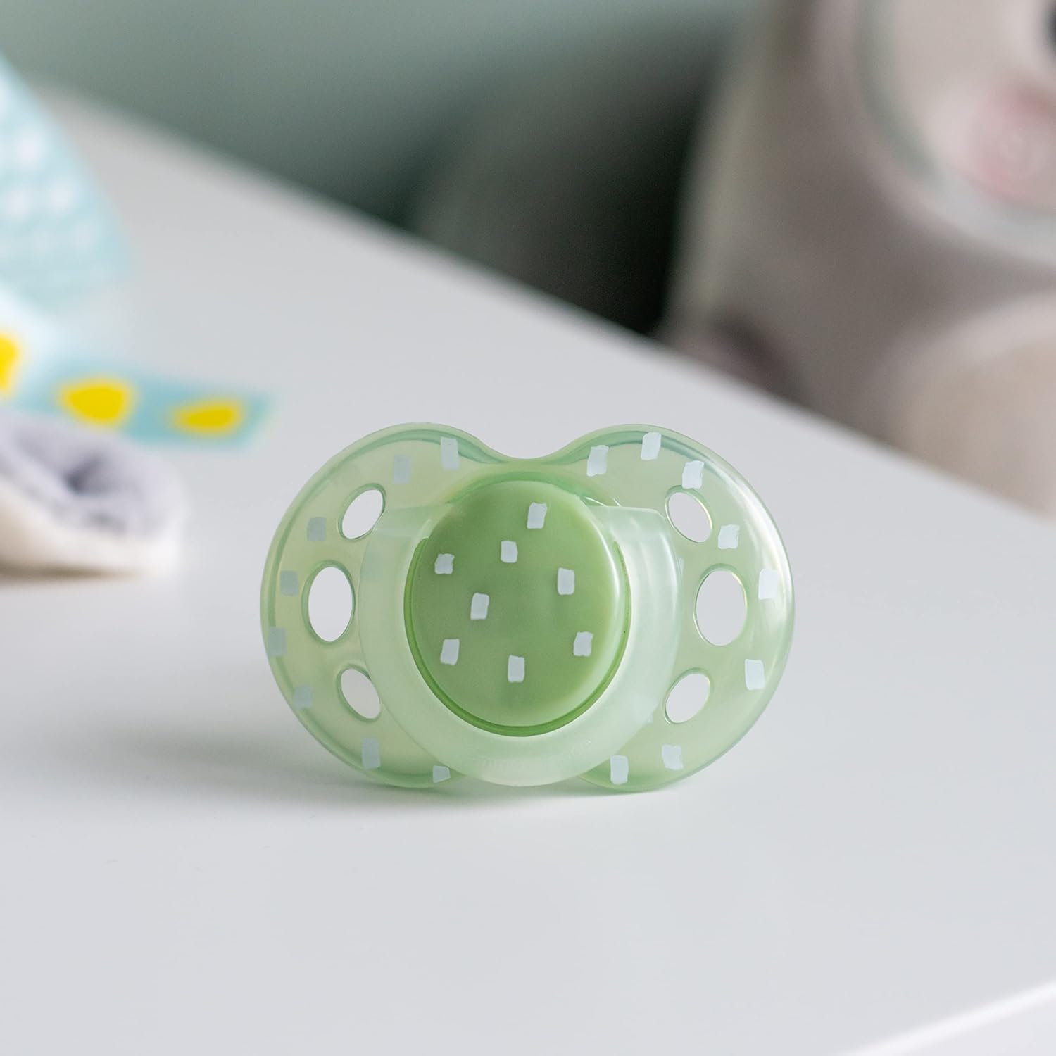Shows the pacifier in a real-world context to help parents visualize how it would look when used by their baby.