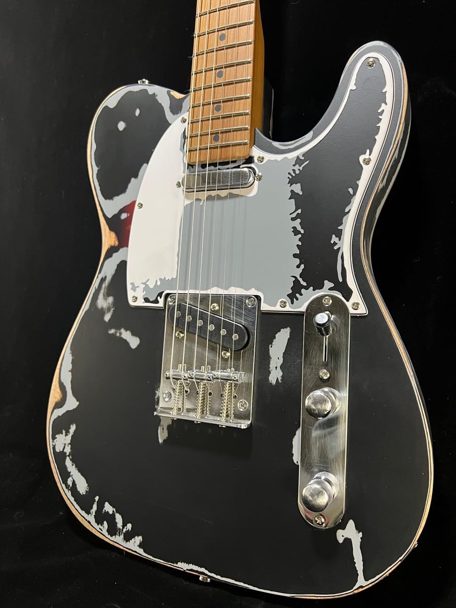Highlights the unique distressed finish of the guitar, appealing to musicians who prefer a vintage or worn look.