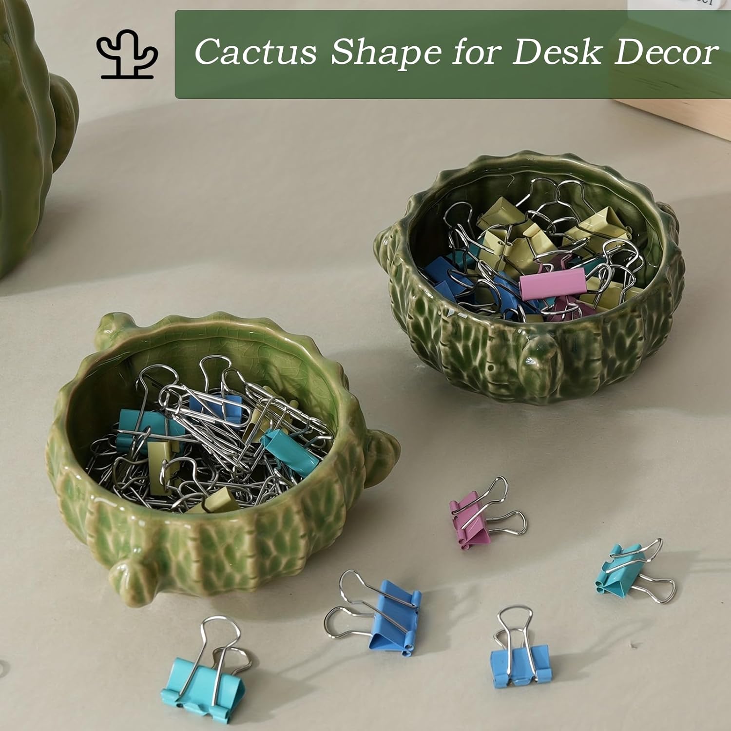 Demonstrates how the cactus-shaped containers can be used for organizing small office supplies like binder clips, enhancing desk decor.