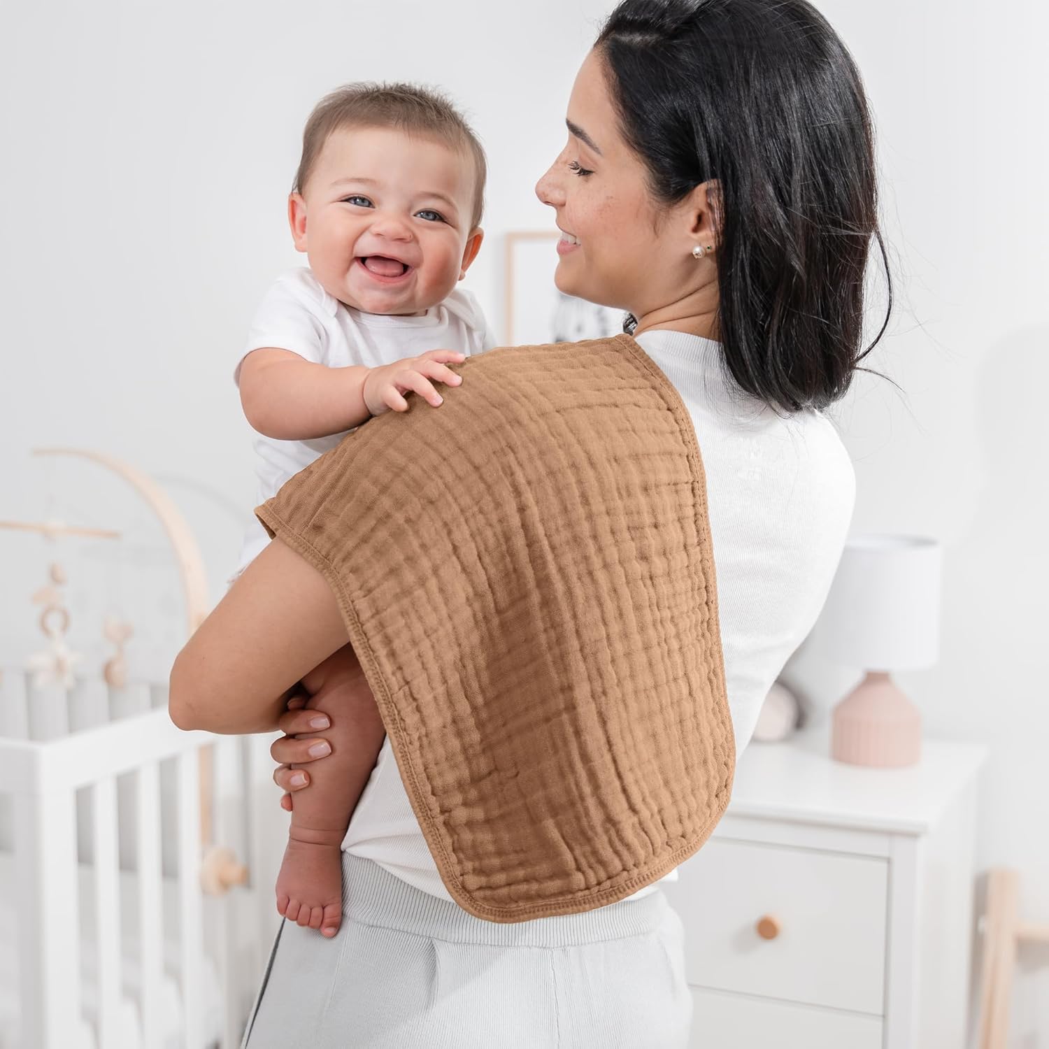 Shows the product in use, highlighting the comfort and happiness of both mother and baby to appeal to new parents.