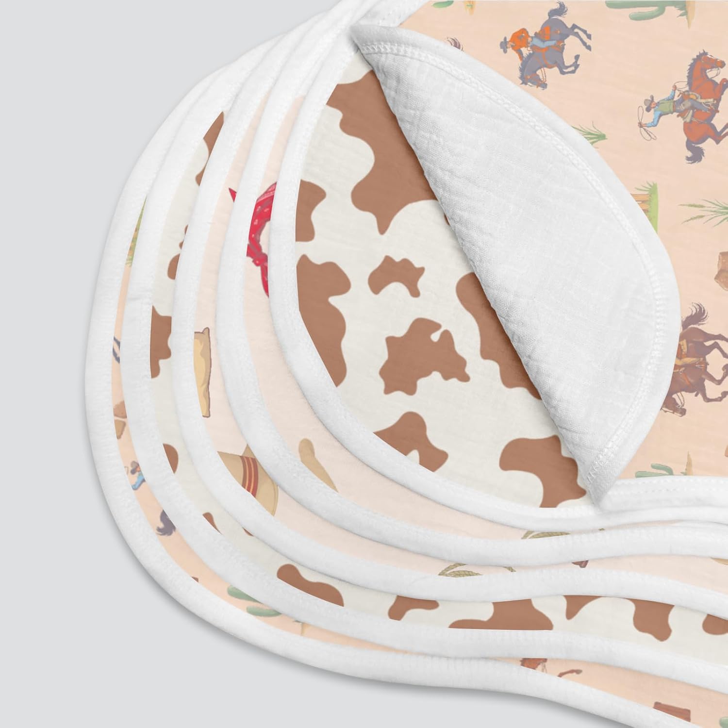 Showcases the variety of fabric patterns included in the product, likely a set of baby bibs or blankets.