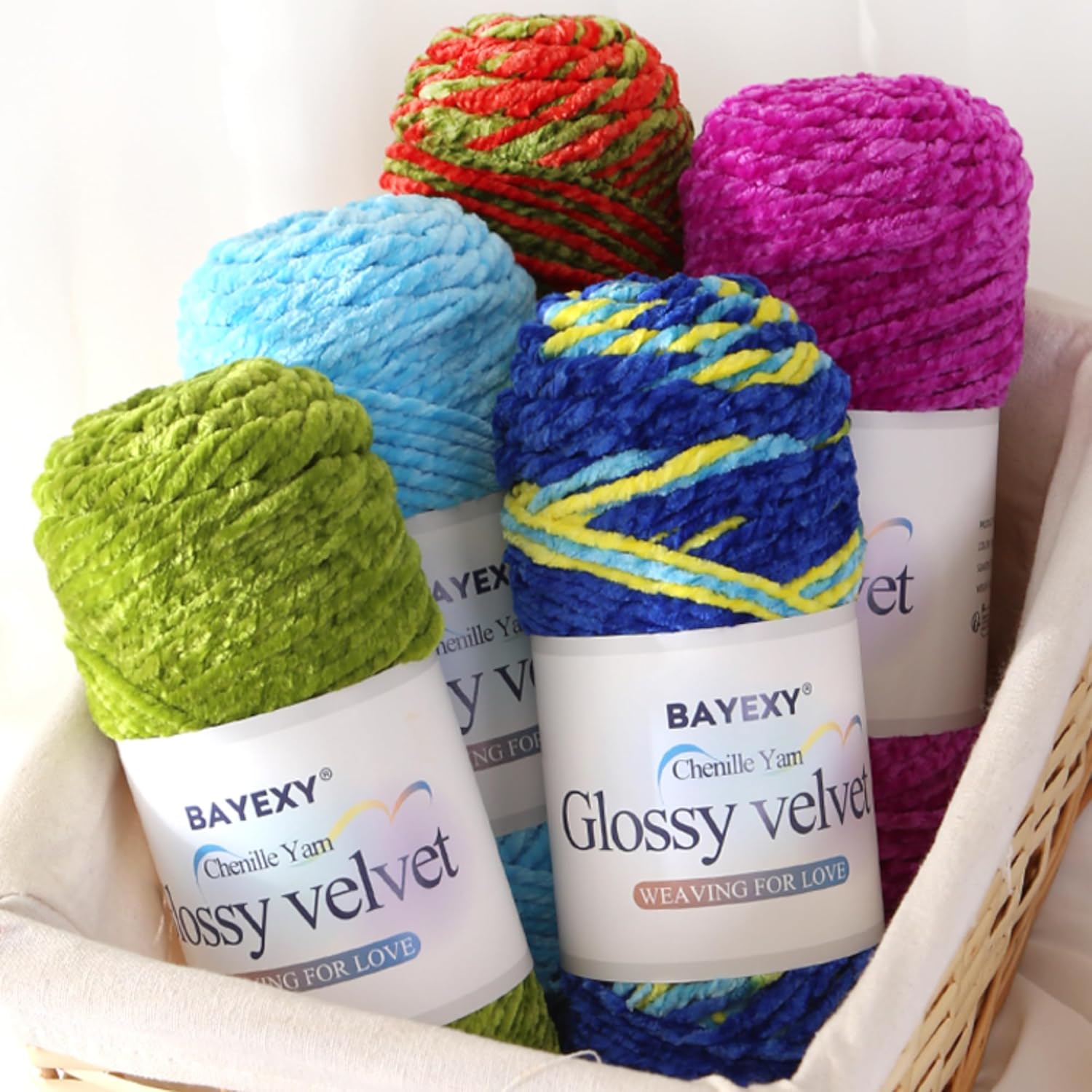 Shows the variety of colors available in the Bayexy Glossy Velvet chenille yarn collection, highlighting the product range to appeal to crafters.