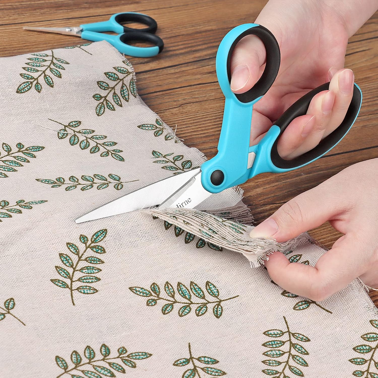 Demonstrates how to use the scissors to cut fabric, showcasing the product's precision and ease of use for crafting projects.