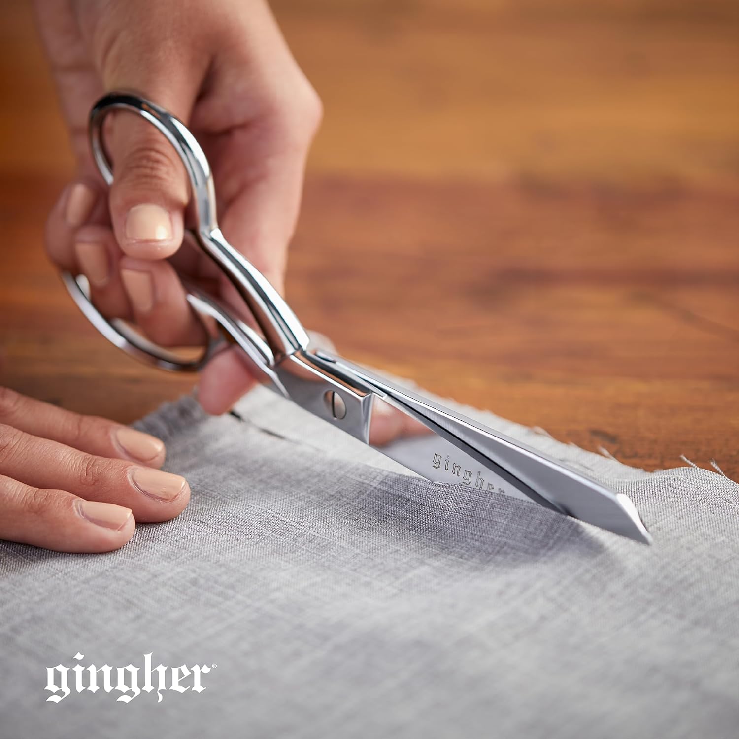 Demonstrates the scissors' ability to make precise cuts on fabric, highlighting their sharpness and quality for sewing or crafting tasks.