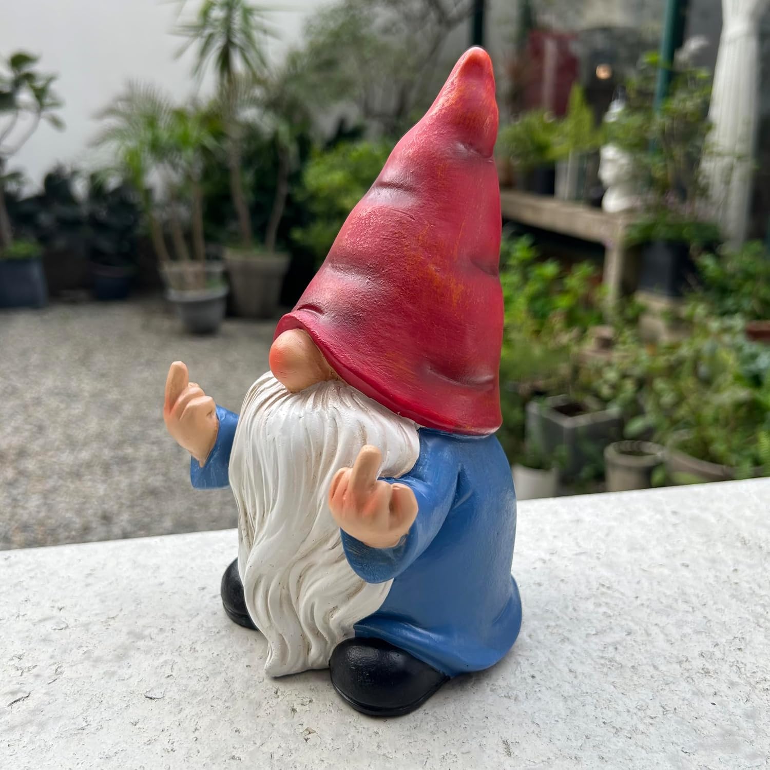 Shows the product in a natural outdoor setting to demonstrate its use as garden decor.