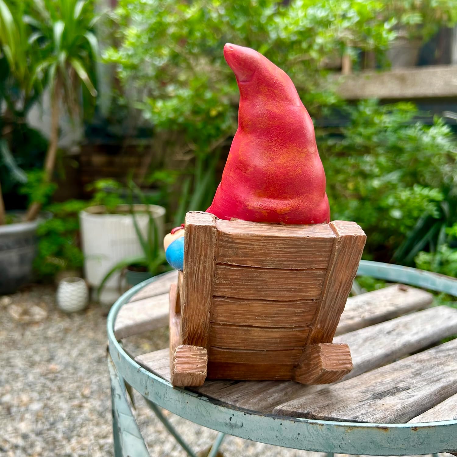 Shows the product in a natural outdoor setting to demonstrate its use as garden decoration.