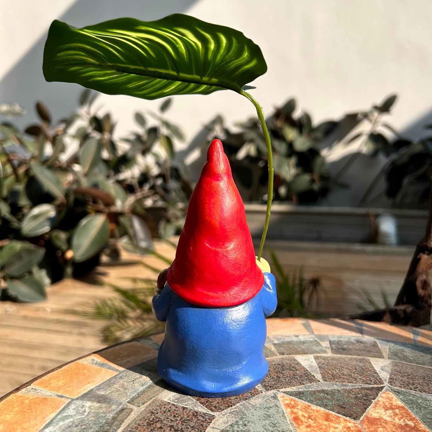 Shows the product in a natural outdoor setting to demonstrate its use as garden decor.